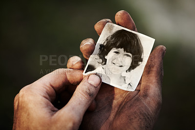 Buy stock photo A dirty hand holding a black and white picture of a little boy