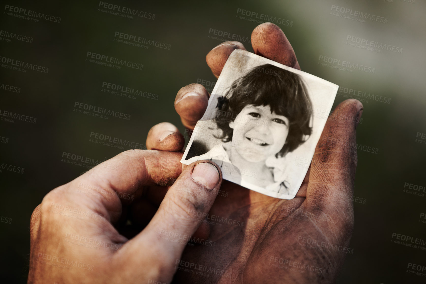 Buy stock photo A dirty hand holding a black and white picture of a little boy