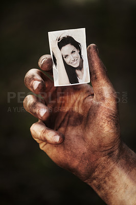 Buy stock photo Hand, holding picture of woman and portrait, retro nostalgia or remember memory of family or partner isolated on background in studio. Closeup, black and white photo of wife and dirty fingers of man