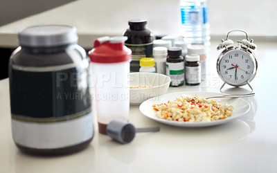 Buy stock photo Table closeup, food and supplement in kitchen for health, diet goal or schedule in home with clock. Meal plan, watch and planning for cooking, preparation or nutrition with drugs, lunch or breakfast