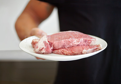 Buy stock photo Food, protein and a plate of raw steak in the hand of a man for diet, nutrition or meal preparation. Kitchen, cooking and meat with a strong male bodybuilder eating beef for a healthy lifestyle