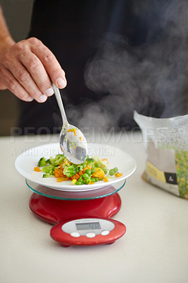 Buy stock photo Scale, food and man with vegetables in kitchen to measure portion for calories, nutrition and balance diet. Cooking, hungry and hands of male person weigh healthy meal for lunch, dinner and supper