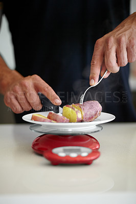 Buy stock photo Scale, food and man weigh vegetable in kitchen to measure portion for calories, nutrition and balance diet. Cooking, meal prep and hands of male person cutting vegetables for lunch, dinner and supper