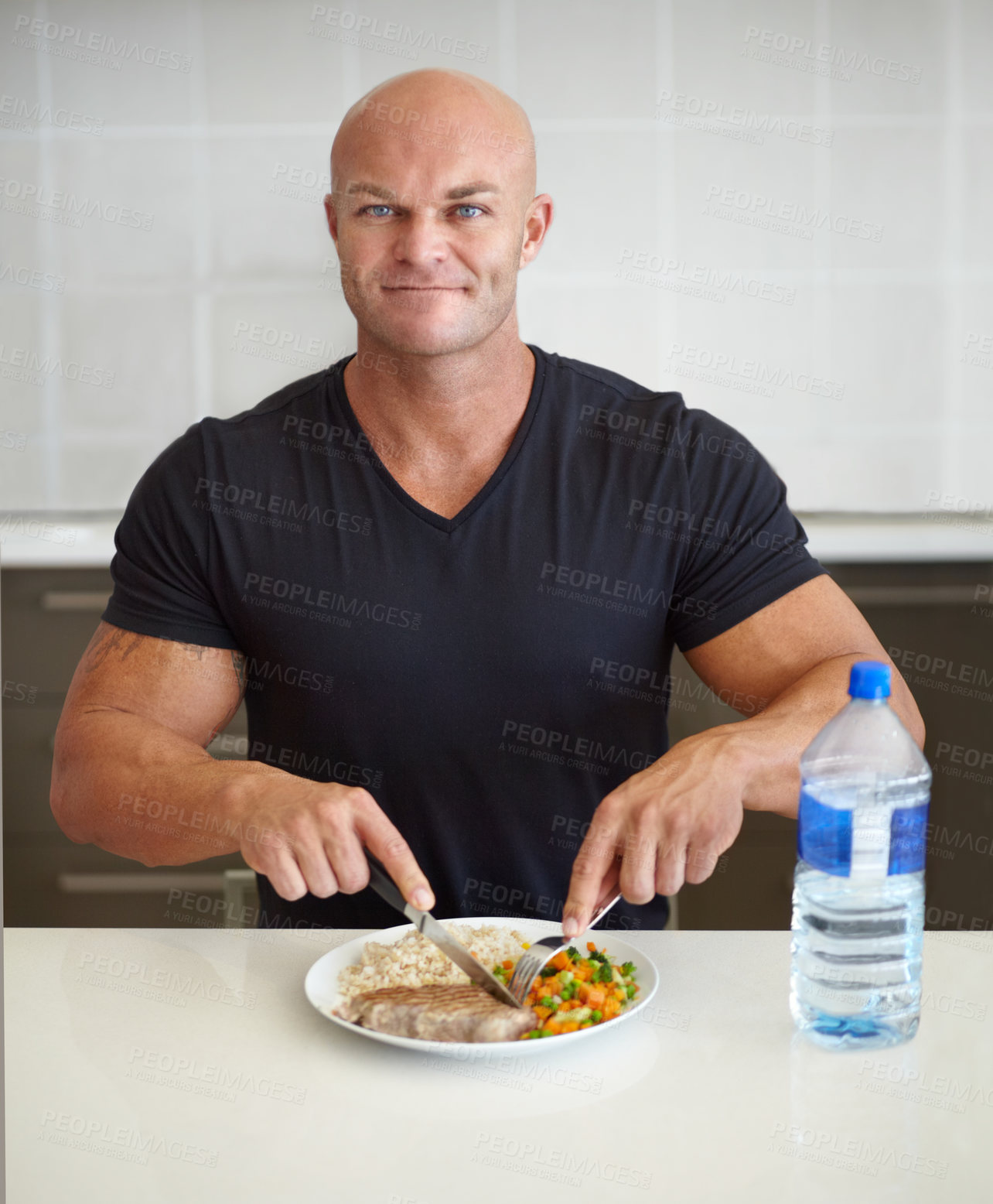 Buy stock photo Bodybuilder man, meal and home in portrait with food, water and healthy protein for wellness, diet or smile. Guy, body builder and eating with dining, nutrition or health at dinner for lifestyle