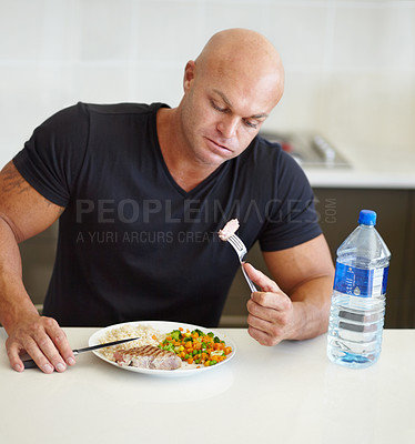 Buy stock photo Bodybuilder man, food and eating in home with meal, water and healthy protein for wellness, diet or hungry. Guy, body builder and steak for dining, nutrition or health at dinner for lifestyle