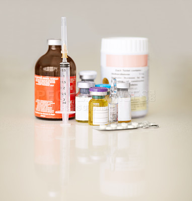 Buy stock photo Bottles of medicine, pills and a syringe or needle on a table for healthcare. Steroids, medical equipment and supplements together for bodybuilder muscle growth or prevention for sickness or disease