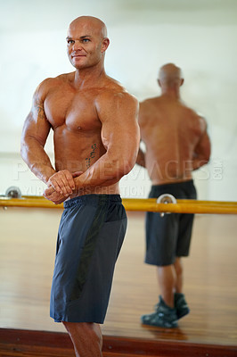 Buy stock photo Man, strong arm and flex in mirror at gym with fitness, workout and exercise of bodybuilder with reflection. Muscle, person and athlete with sport training, wellness and body builder at a health club