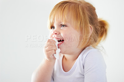 Buy stock photo A cute baby girl laughing while holding a tissue