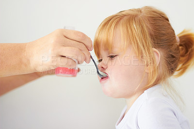 Buy stock photo Girl child, hand and spoon with medicine for healthcare, wellness or help from parent in house. Baby, infant kid or toddler with person, bottle and pharma drugs for vitamin c, immune system or growth