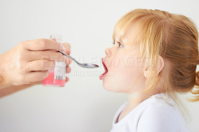 Buy stock photo A cute baby girl with her mouth open to be fed with a spoon