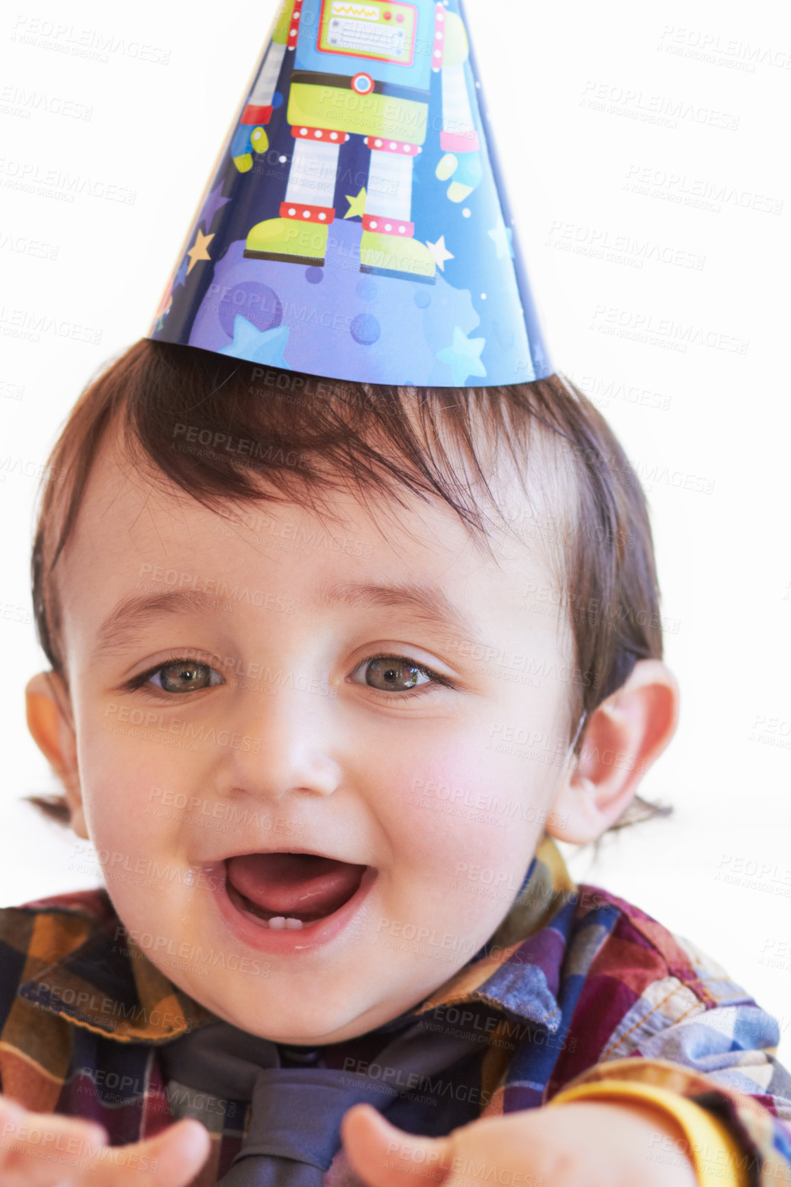 Buy stock photo Shot of a cute little boy wearing a party hat looking excited