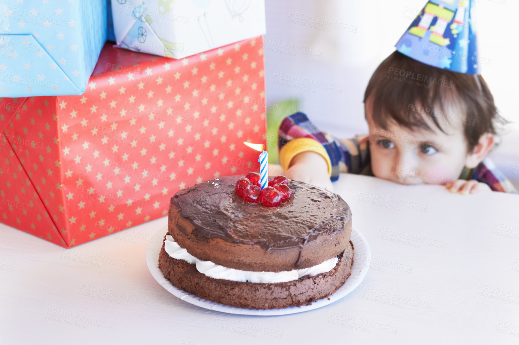 Buy stock photo Birthday cake, kid and curious of food at party with gifts and dessert at home with a hungry child. Chocolate, sneaky and snack to celebrate a boy at a party feeling temptation for sweets in house 
