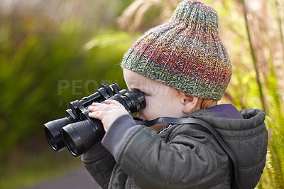 Buy stock photo A cute little boy looking through binoculars