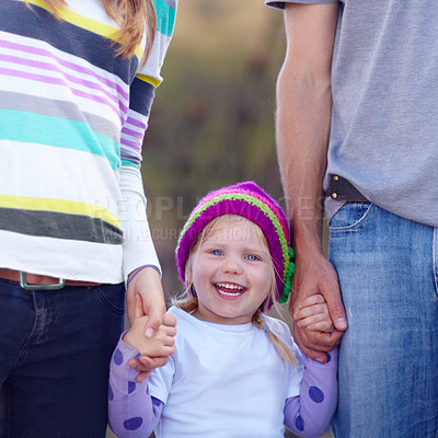 Buy stock photo Portrait of a cute little girl standing in between her mother and father