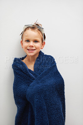 Buy stock photo Portrait, bath and a boy in a towel in studio on a white background to dry after cleaning for hygiene. Children, smile and a happy young kid in the bathroom of his home for skincare or wellness