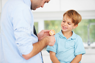 Buy stock photo Father, son or orange fruit eat in home for healthy wellness snack, happy vitality or childhood development. Man, boy child or fresh diet together smile or organic citrus nutrition, fibre or minerals