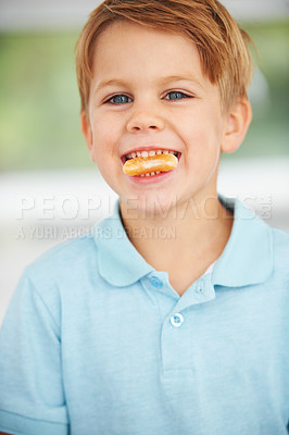 Buy stock photo Child, portrait or orange slice fruit or mouth health snack, vitamin c or raw food youth development. Boy, kid or face fresh smile diet or organic citrus nutrition, fibre breakfast or morning mineral