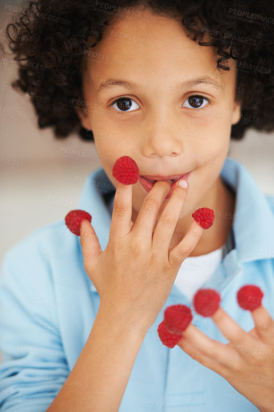Buy stock photo Cute, portrait and boy child with raspberries at home with a health, wellness or diet snack. Smile, nutrition and young kid from Mexico eating healthy berry fruit on his fingers for a treat at home.