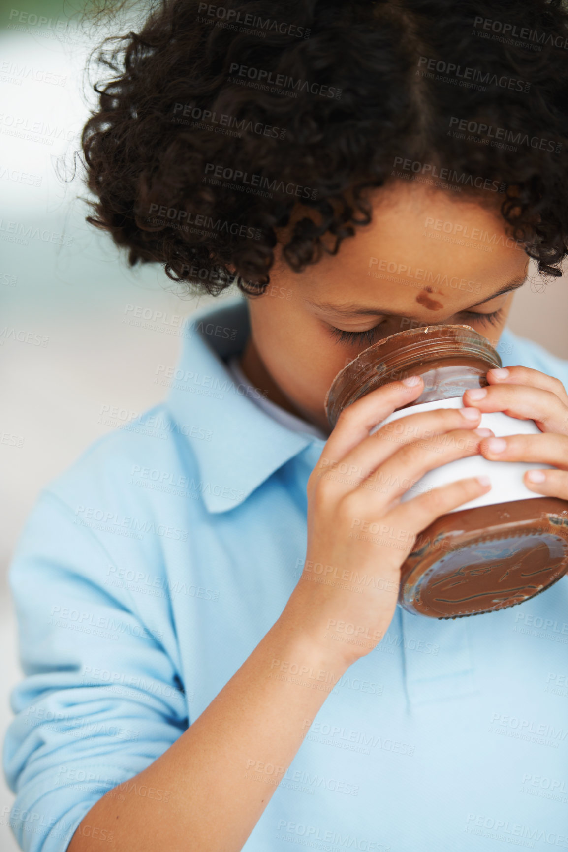 Buy stock photo A little boy eating Nutella from a jar