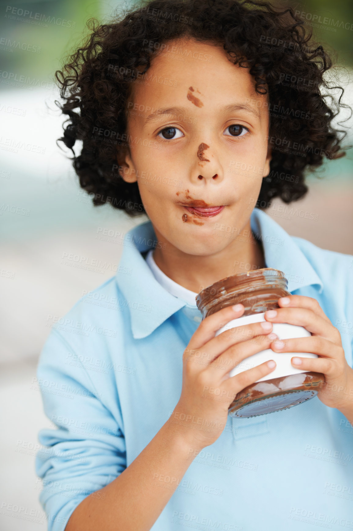 Buy stock photo Cute, portrait and child with chocolate spread at a home with delicious, sweet snack or treat. Smile, happy and face of young boy kid from Mexico eating nutella jar licking lips at modern house.