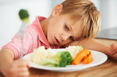 Buy stock photo Sad, healthy and a child with vegetables for dinner, unhappy and problem with food. Frustrated, hungry and a little boy eating broccoli and carrots, disappointed with lunch and nutrition for youth