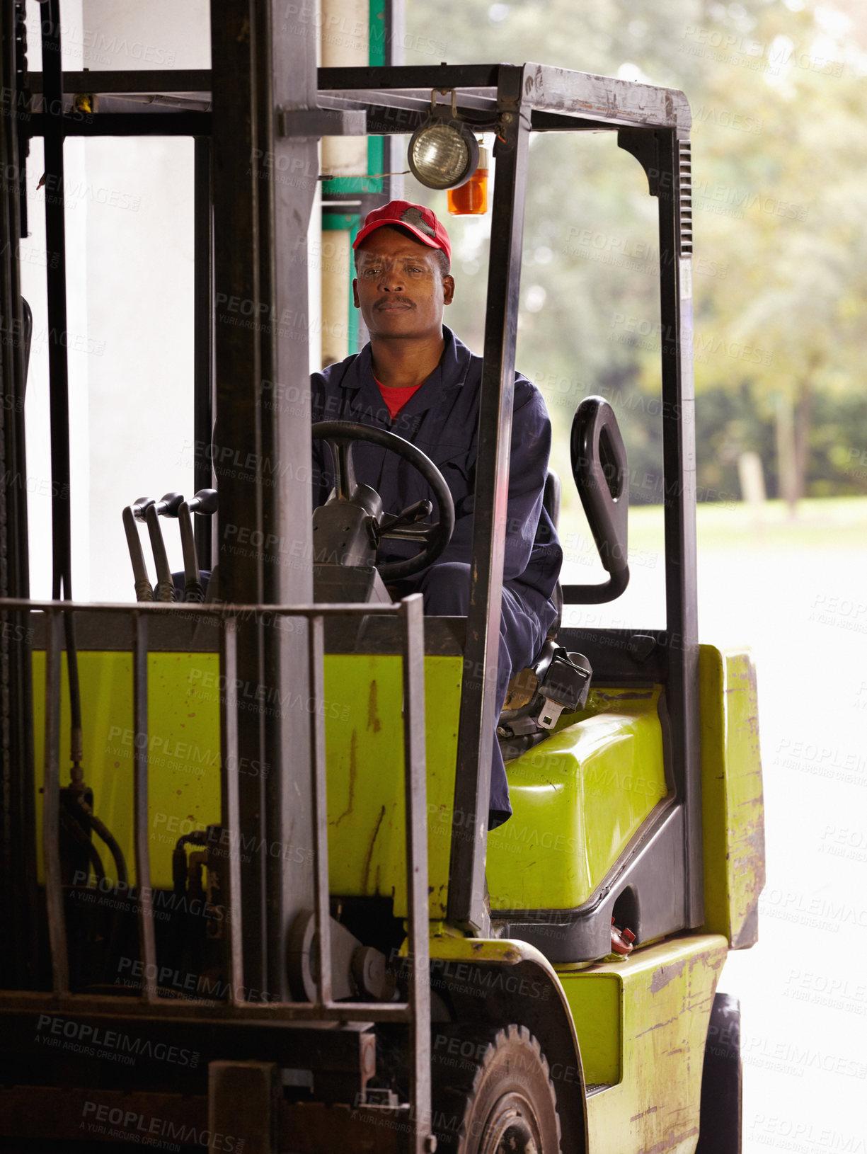 Buy stock photo A worker operating a forklift indoors