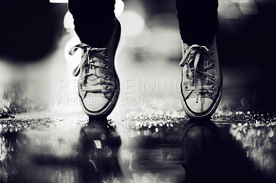 Buy stock photo Balance, shoes or fashion in monochrome on an urban street outdoor for dance or contemporary style. Feet, sneakers or footwear in black and white in a city to explore for travel, tourism or adventure