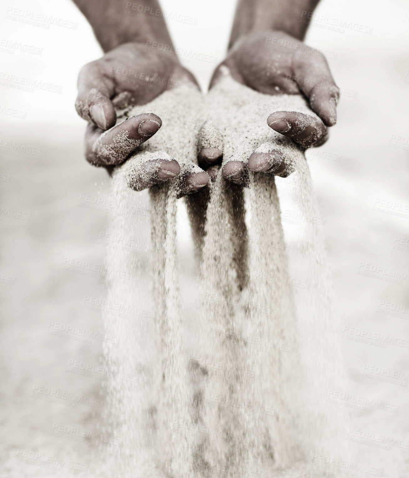 Buy stock photo Shot of a man with a handful of sand falling through his fingers