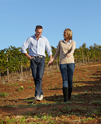 Buy stock photo A mature wine maker and his wife taking a stroll through the vineyard