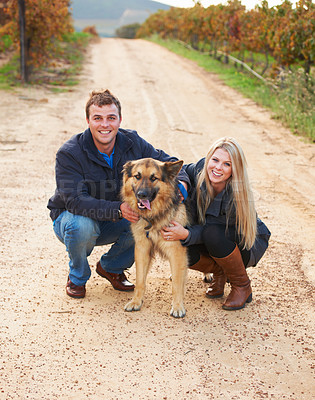 Buy stock photo Portrait, nature and a couple walking their dog outdoor on a dirt road while bonding together for love. Happy, agriculture or sustainability with a man and woman taking their pet for a walk on a farm