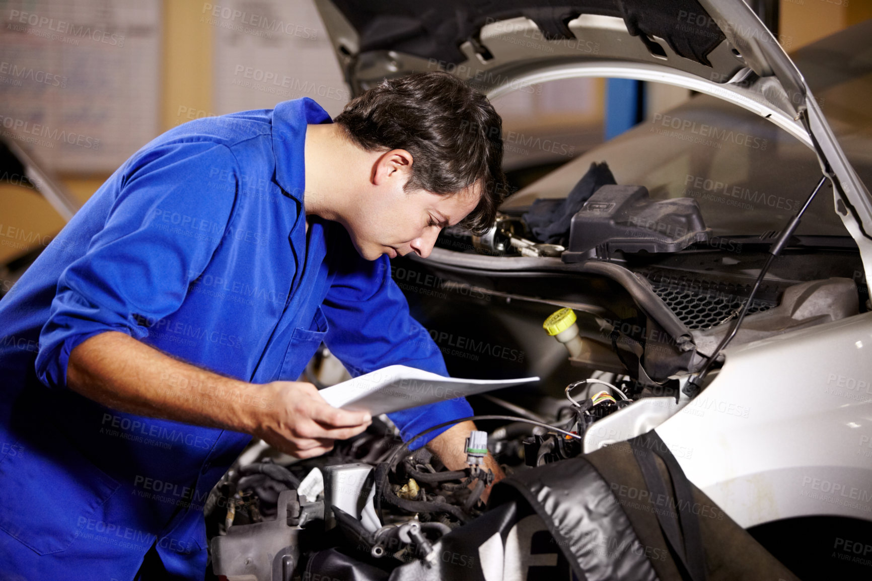 Buy stock photo Car, service and repair with a mechanic man in a workshop as an engineer looking at the engine of a vehicle. Garage, report or quote with a young technician working under the hood of an automobile