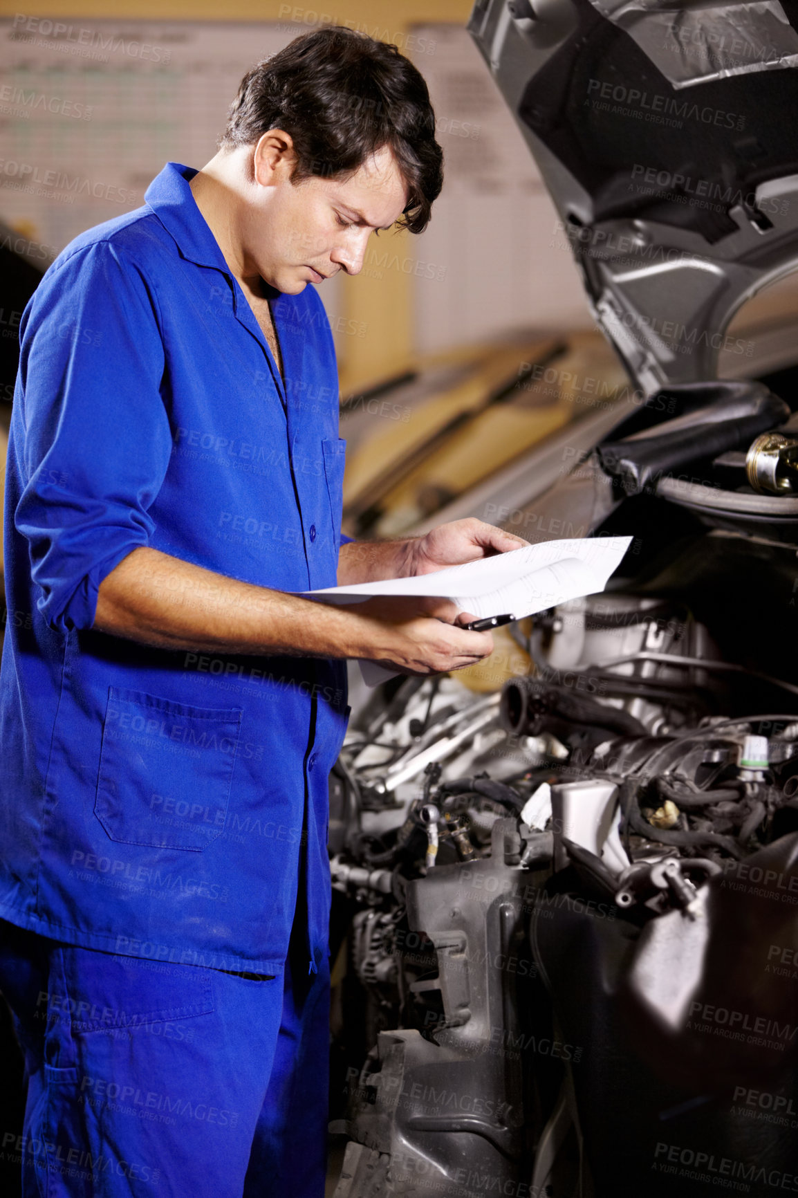 Buy stock photo Paperwork, man and mechanic reading at engine of car, repair and maintenance. Checklist, technician and serious person on motor vehicle hood, inspection list and fix transport at auto service garage