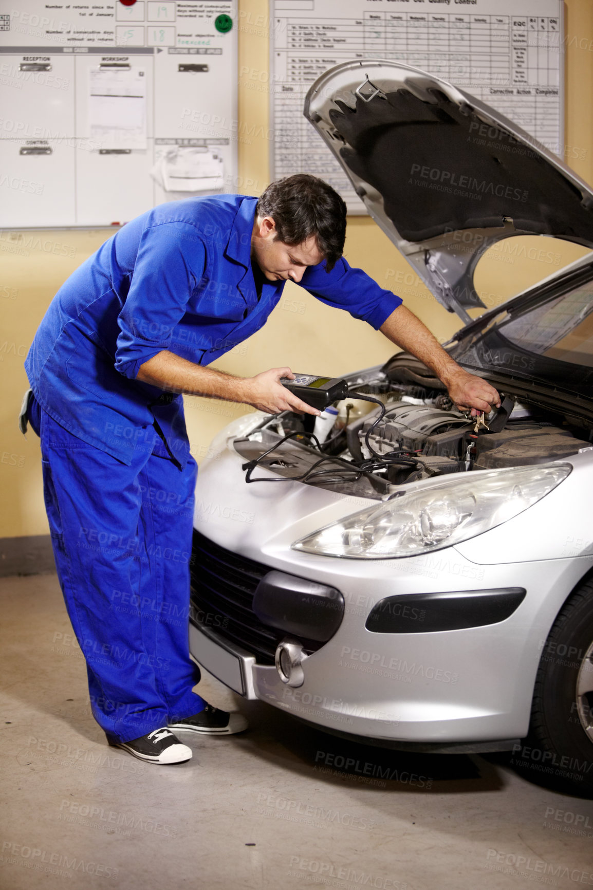 Buy stock photo Car, service and diagnostic with a mechanic man in a workshop as an engineer looking at an engine of a vehicle. Garage, repair or quote with a young technician working under the hood of an automobile