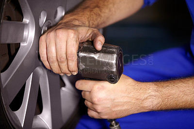 Buy stock photo Hands, mechanic and change wheel in shop, electric drill and car service or auto repairs for maintenance. Technician, person and tire safety for automobile, rim and vehicle inspection in workshop