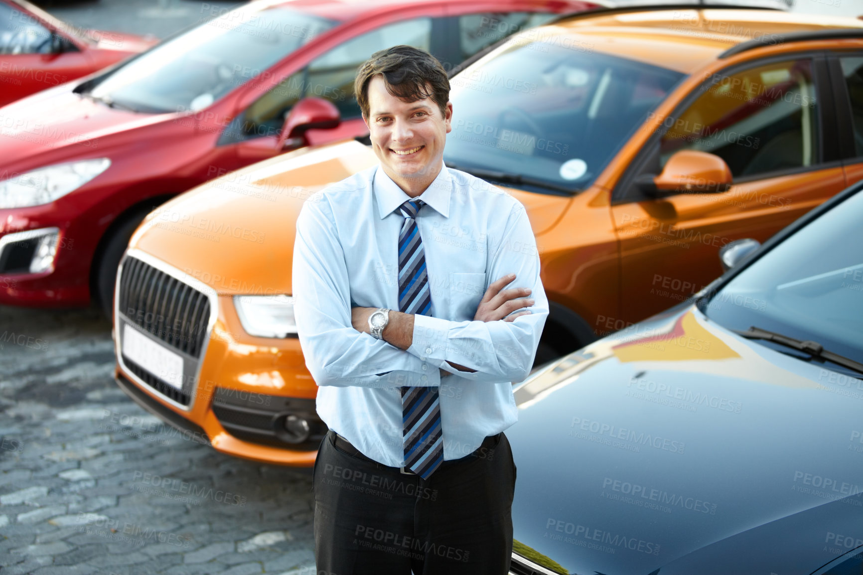 Buy stock photo Portrait, smile and a man arms crossed at a dealership for car sale in a commercial parking lot. Business, luxury and automobile trade with a happy young salesman outdoor for transport service