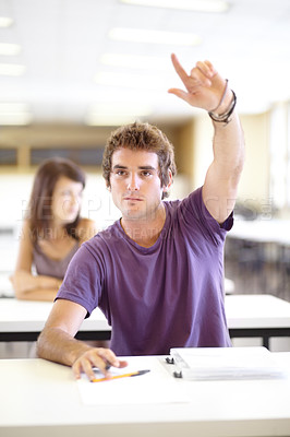 Buy stock photo A young caucasian man raising his hand in class to ask a question