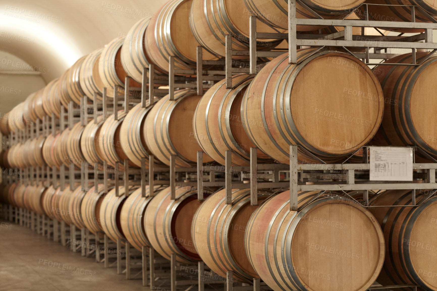 Buy stock photo Stacked barrels of wine at a wine distillery