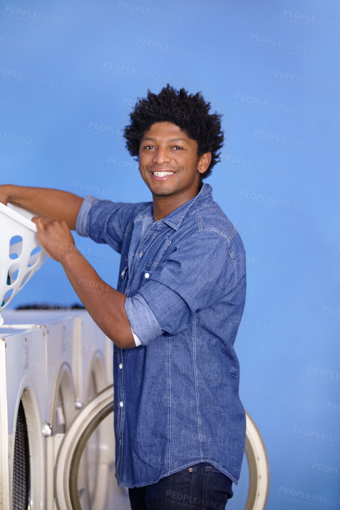 Buy stock photo Laundry, portrait of a black man at washing machine and basket at laundromat with a smile. Hygiene, service and African male person cleaning clothes for health wellness or protection from bacteria