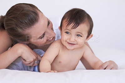 Buy stock photo Happy, bedroom and relax baby with mom for morning rest, childhood and enjoy fun bonding time together. Child growth, family happiness and playing mother, mama or woman tickle infant toddler on bed