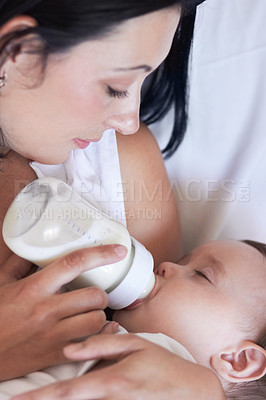 Buy stock photo Baby, feeding and mom with child at home with a bottle of milk with parent care with kids. Family, young youth and drink for growth and development with a mother feeling proud from childcare in house