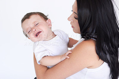Buy stock photo A mother holding her crying baby boy