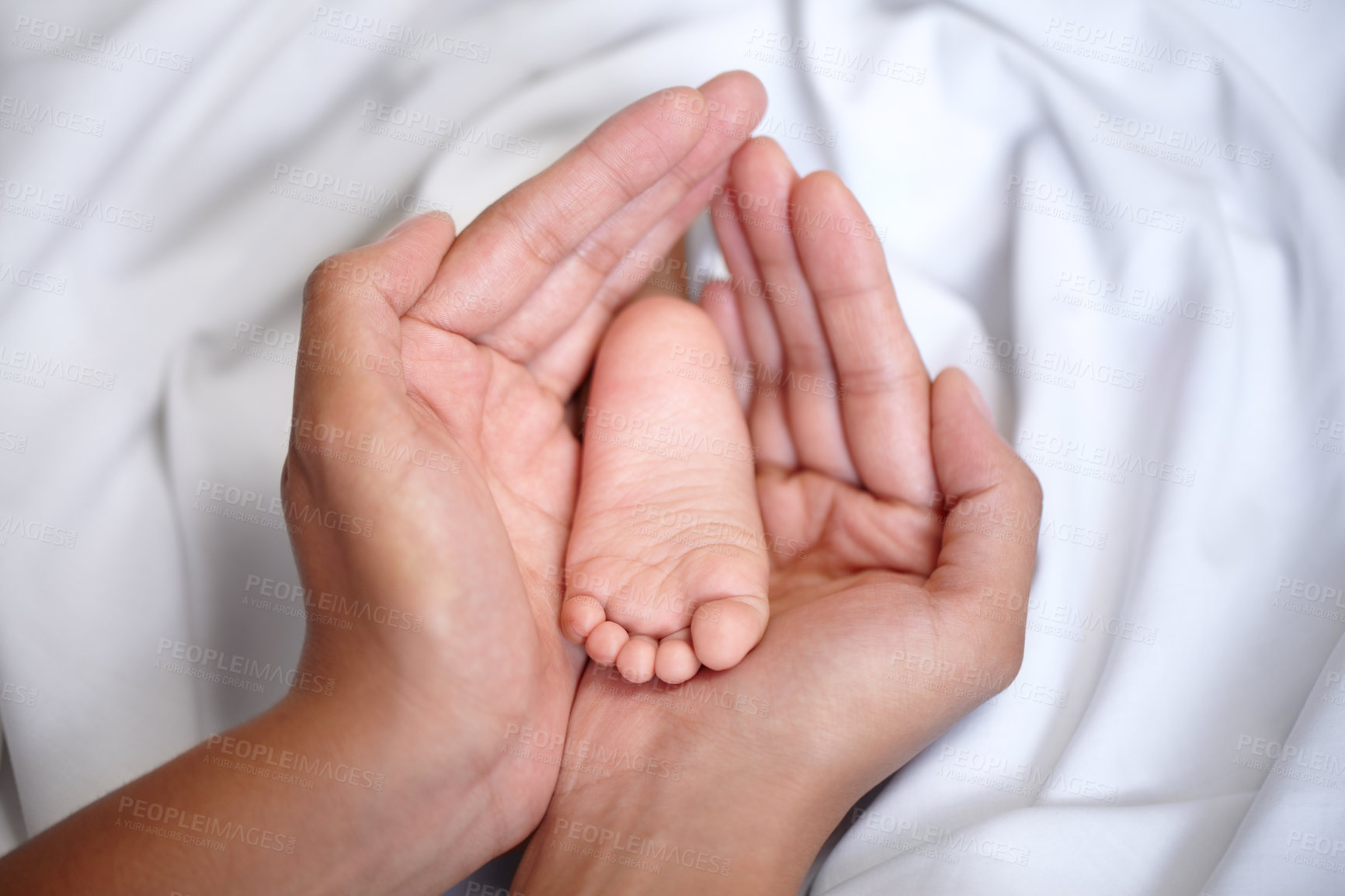 Buy stock photo Hands, newborn and closeup of a baby foot with mother holding for care, love and nurture. Childcare, cute and zoom of a woman with her infant child feet in the crib of nursery at their family home.