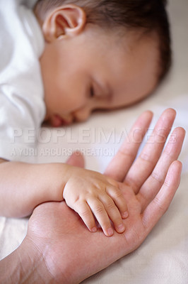 Buy stock photo Closeup, hands and baby sleeping, care and nurture with love, support and relaxing with protection. Zoom, fingers and palms with infant, toddler or newborn with mother, asleep and family with comfort