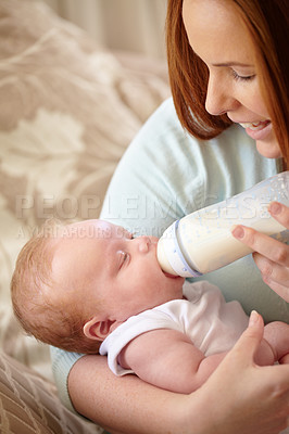 Buy stock photo Mother, baby and feeding milk from bottle for nutrition, healthy breakfast and diet in the morning. Mom, child and feed newborn formula food for growth, development and wellness in happy home bedroom