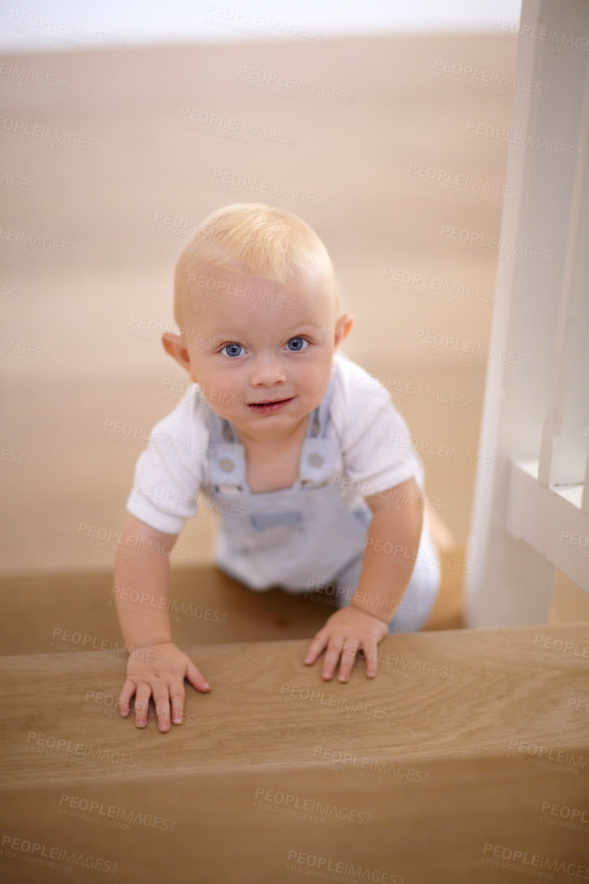 Buy stock photo Happy, portrait of baby crawling and at his home with a smile at the stairs. Happiness or childhood development, excited or cheerful and boy child crawl at his house by the staircase smiling