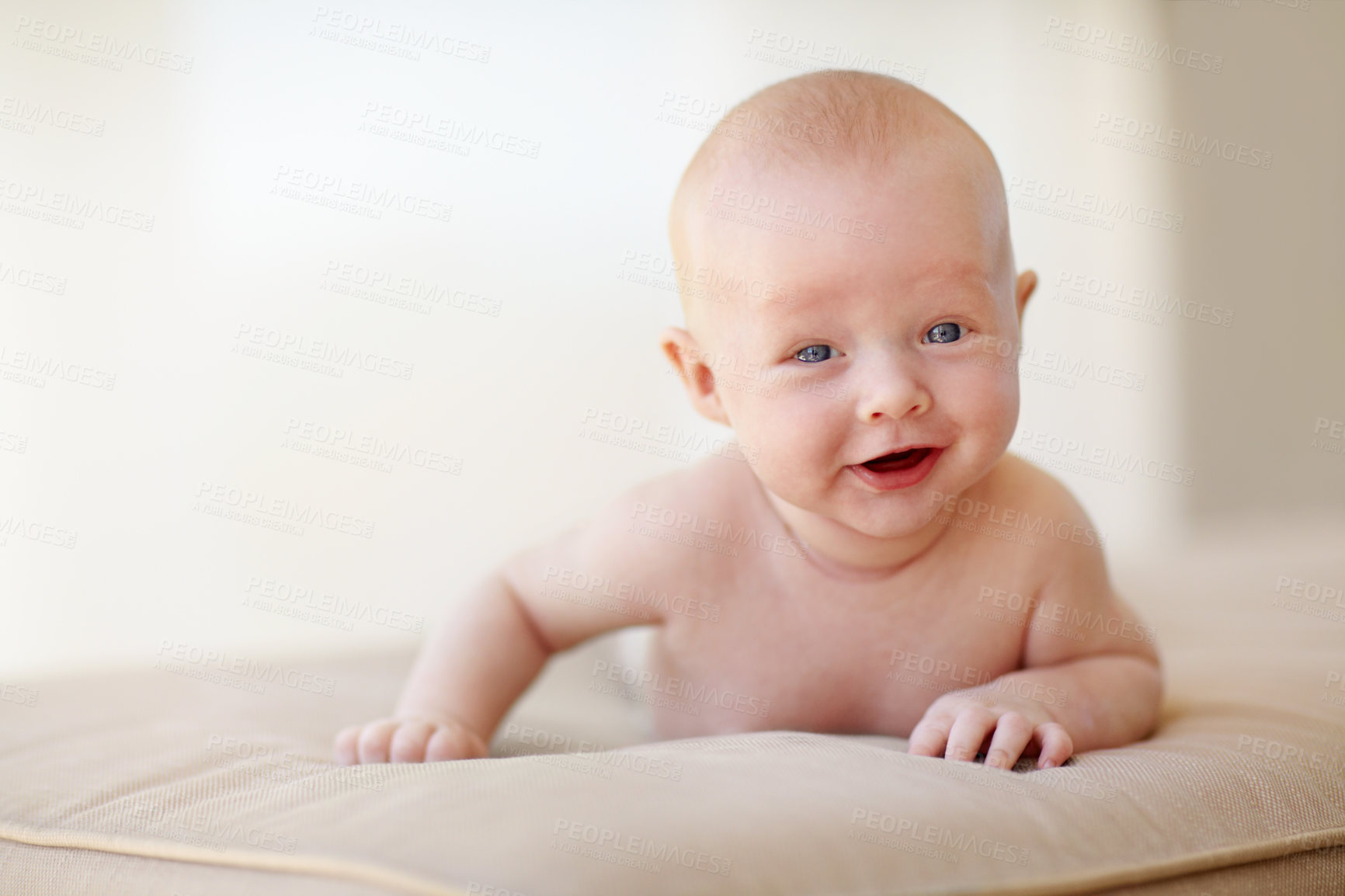 Buy stock photo Newborn, baby or portrait on sofa for healthy childhood development, growth or learning. Infant, smile or face on stomach or curious interest or search environment, safety or discovery time in lounge
