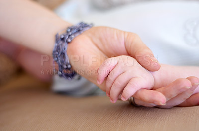 Buy stock photo Love, family and mother holding hands with her baby in the home for trust, care or bonding together closeup. Children, hand or comfort with a mama and newborn infant in a house to nurture growth