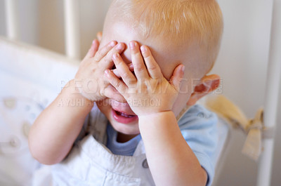 Buy stock photo High angle view of a baby boy covering his eyes playfully
