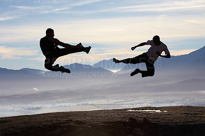 Buy stock photo Flying, kick and karate men on mountain top for fitness, training or body, speed or power on sky background. Martial arts, taekwondo or MMA friends in nature with jump, fighting or sports exercise