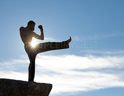 Buy stock photo Karate, fitness man kick on mountain top for body, power or defense training on blue sky background. Martial arts, MMA and male taekwondo master in nature for exercise, sports or morning cardio